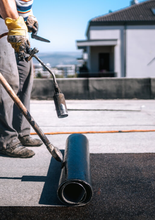 Weathercraft workers working on a flat roof